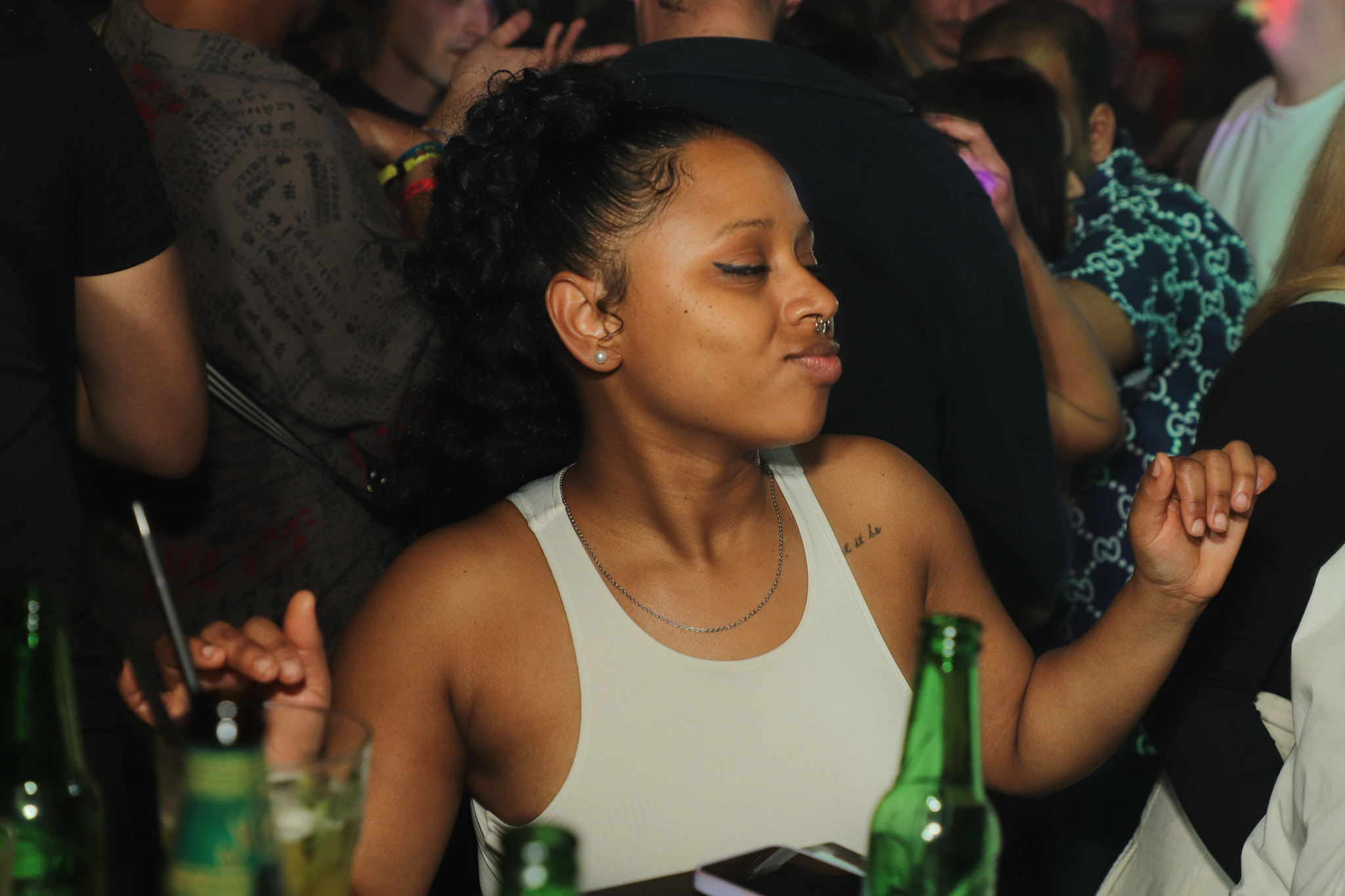 A woman dancing and enjoying the music at her table.